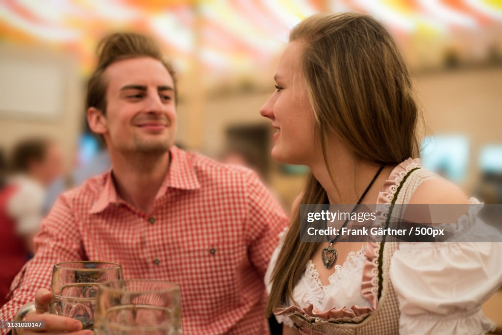 Young Couple Flirting In Beer Fest Beer Tent