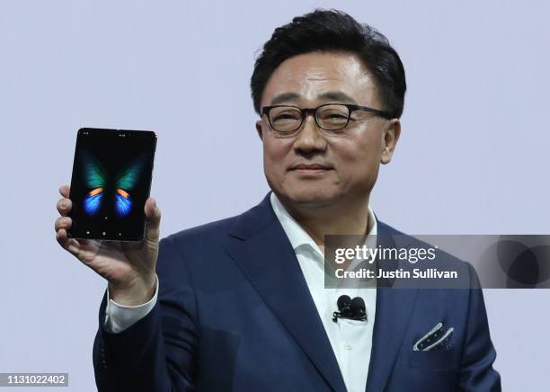 Samsung's Mobile Division President and CEO DJ Koh holds the new Samsung Galaxy Fold smartphone during the Samsung Unpacked event on February 20,...