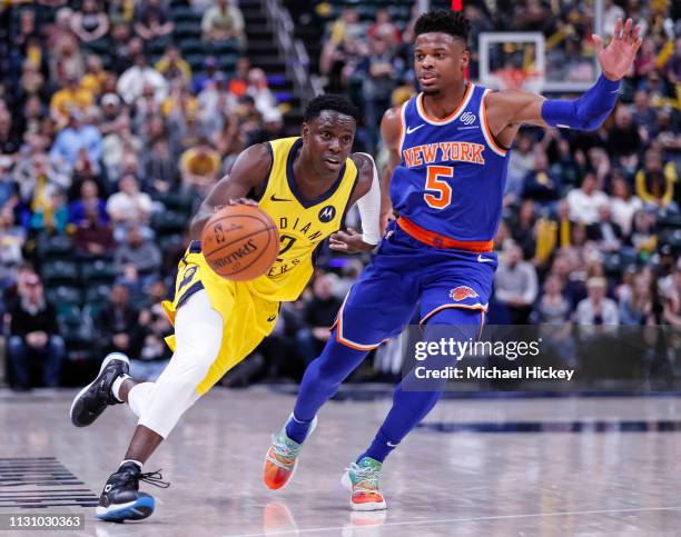 Darren Collison of the Indiana Pacers dribbles the ball against Dennis Smith Jr. #5 of the New York Knicks at Bankers Life Fieldhouse on March 12,...