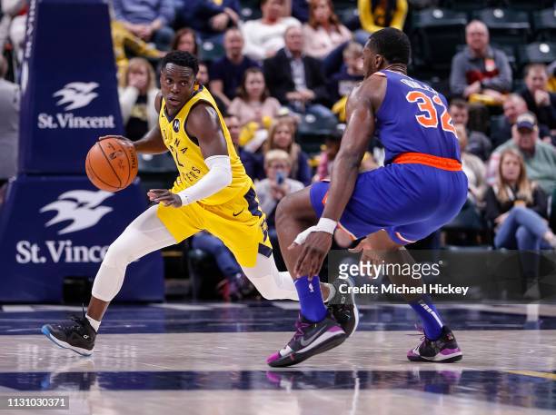 Darren Collison of the Indiana Pacers dribbles the ball during the game against Noah Vonleh of the New York Knicks at Bankers Life Fieldhouse on...