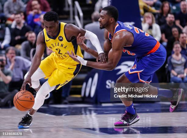 Darren Collison of the Indiana Pacers dribbles the ball during the game against Noah Vonleh of the New York Knicks at Bankers Life Fieldhouse on...