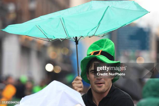 Tourist enjoys in Temple Bar on the eve of St Patrick's Day celebrations. On Saturday, March 16 in Dublin, Ireland.