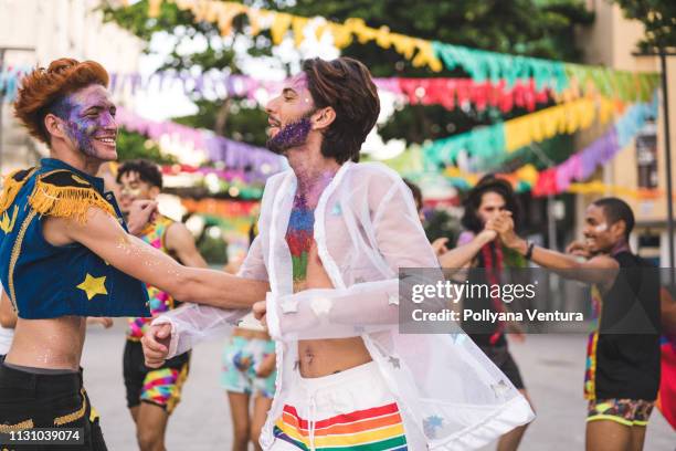friends dancing on the street - gay pride costumes stock pictures, royalty-free photos & images