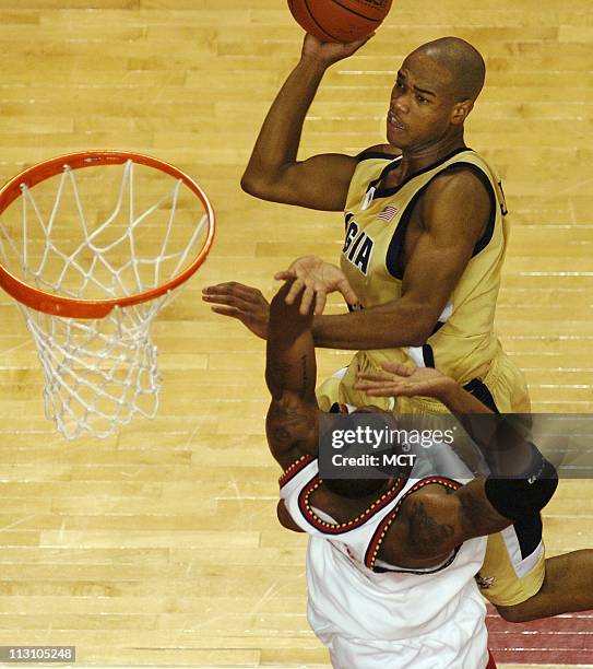 Georgia Tech's Jarrett Jack attempts a shot over Maryland's Travis Garrison in the second half of the Yellowjackets 79-71 loss to the Terrapins,...