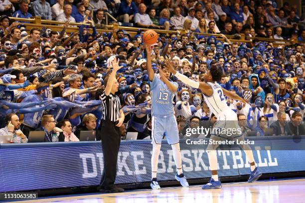 Cameron Johnson of the North Carolina Tar Heels tries to throw the ball in bounds against Cam Reddish of the Duke Blue Devils during their game at...
