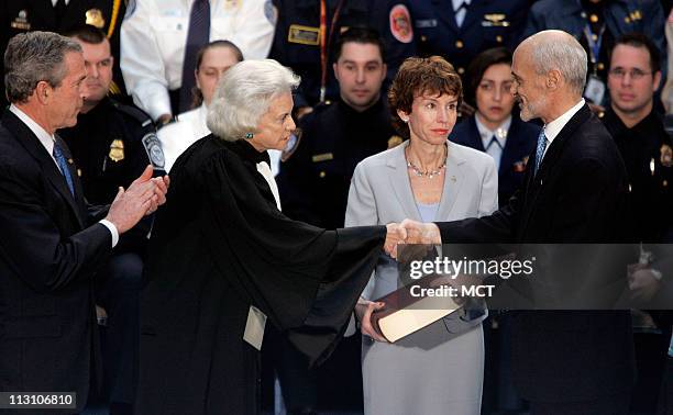 President George W. Bush looks on as U.S. Supreme Court Justice Sandra Day O'Connor congratulates new U.S. Department of Homeland Security Secretary...