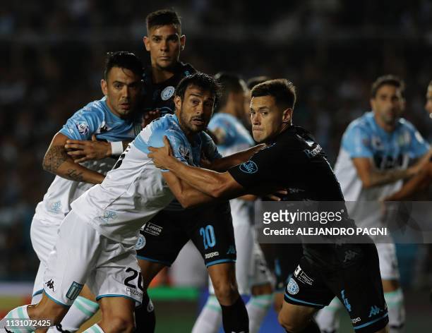 Belgrano's defender Tomas Guidara struggles with Racing Club's forward Dario Cvitanich during their Argentina First Division Superliga football match...