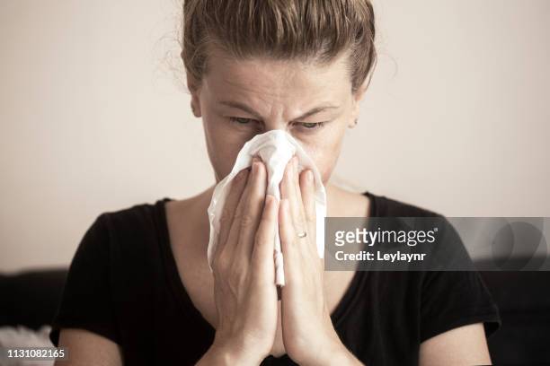 blowing nose - allergies indoors stock pictures, royalty-free photos & images