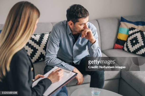 young man, alcoholic, on  therapy session - psychotherapy stock pictures, royalty-free photos & images