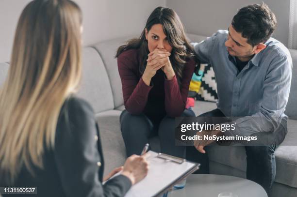 young couple on counseling appointment during pregnancy - psychiatrist's couch stock pictures, royalty-free photos & images