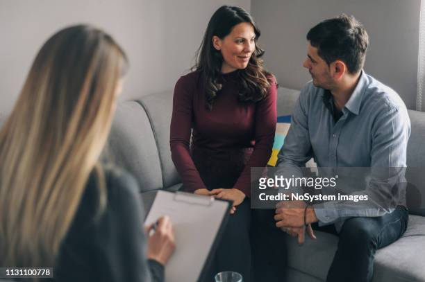 young couple on counseling appointment during pregnancy - couple counselling stock pictures, royalty-free photos & images