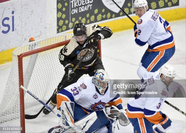 Hershey Bears right wing Riley Barber is hit into the net by Bridgeport Sound Tigers defenseman Seth Helgeson behind Bridgeport Sound Tigers goalie...