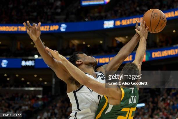 Treveon Graham of the Brooklyn Nets fights for the ball with Raul Neto of the Utah Jazz during a game at Vivint Smart Home Arena on March 16, 2019 in...