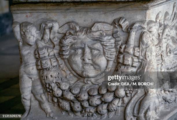 Relief depicting a naked genius holding a garland and a large gorgoneion, sarcophagus of Caius Bellicus Natalis Tebanianus, Monumental Cemetery of...