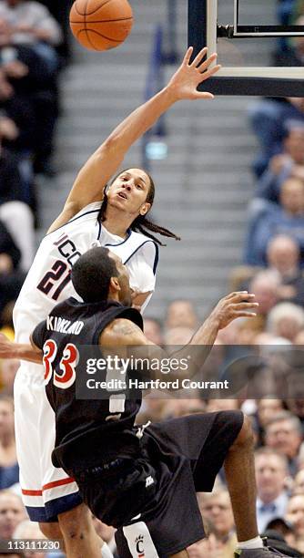 Cincinnati's guard Armein Kirkland injures his knee going up for a shot over Josh Boone during first half action. Connecticut defeated Cincinnati...