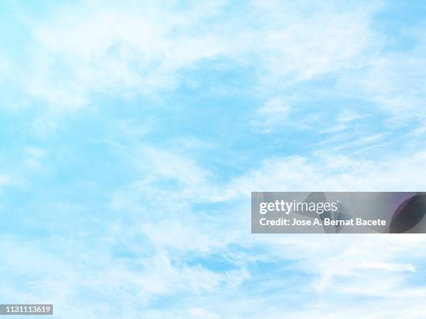 background of a sky of light blue soft color with white clouds. - aire fotografías e imágenes de stock