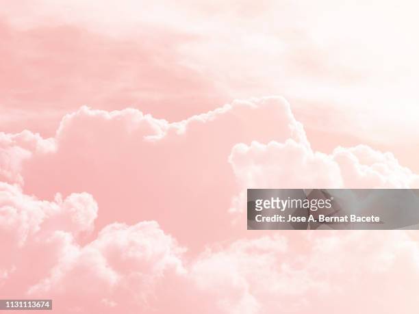background of a sky of pink soft color with white clouds. - clouds background stockfoto's en -beelden