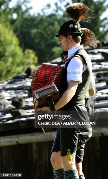 Accordion player in traditional dress, Museum of Kramsach, Tyrol, Austria.