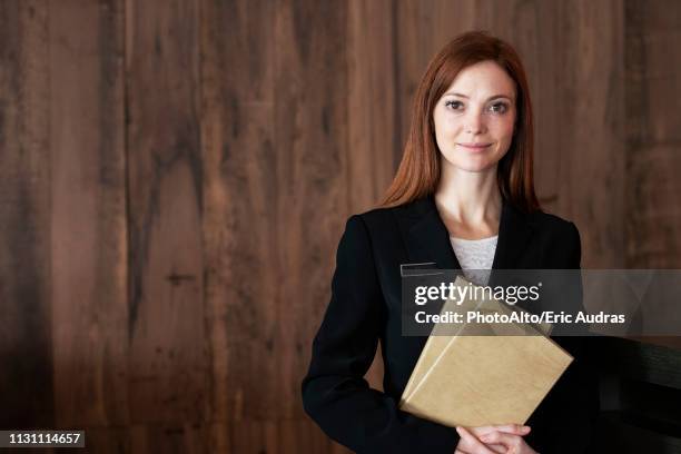 female receptionist standing in hotel - concierge ストックフォトと画像