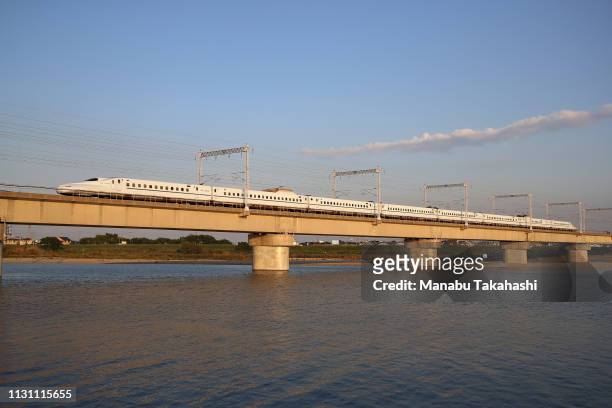 Shinkansen bullet train runs cross Kakogawa River between Nishi-Akashi and Himeji Stations on October 19, 2018 in Takasago, Hyogo, Japan.