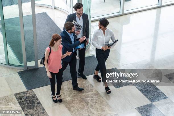 business people talking with each other in hotel lobby - come ストックフォトと画像