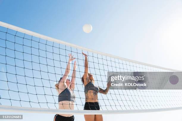 young women playing volleyball - women beach volleyball championship stock pictures, royalty-free photos & images