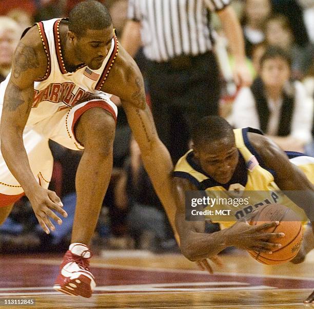 Georgia Tech's D'Andre Bell, right, dives for a ball in front of Maryland's Travis Garrison in the second half of the Terrapins' 87-84 overtime...