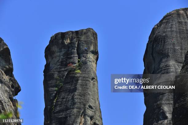 Rock climbers at Meteora, Trikala, Thessaly, Greece.