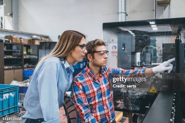 business colleagues using computer in industrial production line - finger goggles stock pictures, royalty-free photos & images