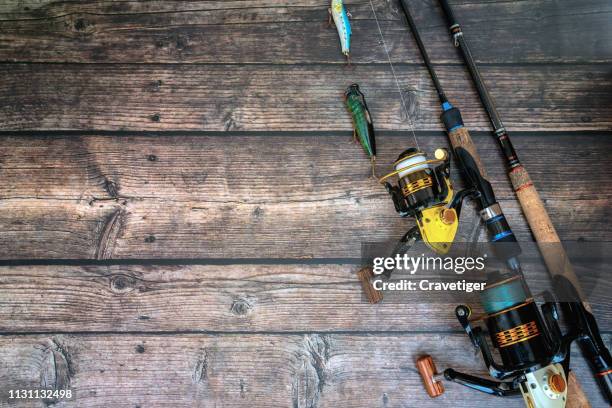 fishing tackle on the wood background. - vishaak visgerei stockfoto's en -beelden