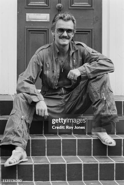 Finnish-born Swedish fashion designer and fashion icon Sighsten Herrgard wearing jumpsuit and jelly sandals, UK, 27th August 1975.