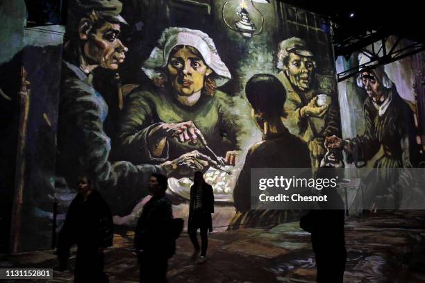 Visitors attend a press preview of the immersive exhibition "Van Gogh, Starry Night" devoted to painter Vincent Van Gogh by multimedia artist...