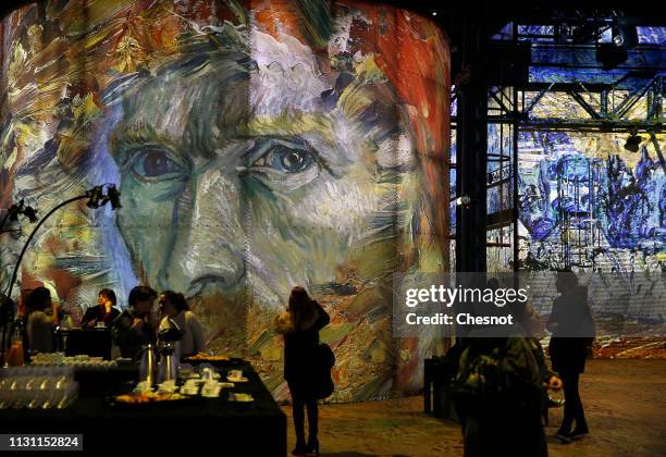 Visitors attend a press preview of the immersive exhibition "Van Gogh, Starry Night" devoted to painter Vincent Van Gogh by multimedia artist...