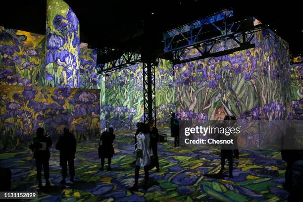 Visitors attend a press preview of the immersive exhibition "Van Gogh, Starry Night" devoted to painter Vincent Van Gogh by multimedia artist...