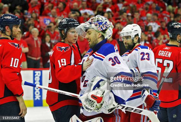 Nicklas Backstrom of the Washington Capitals consoles fellow countrymen Henrik Lundqvist of the New York Rangers during the handshake following a 3-1...