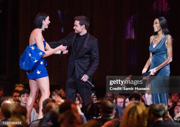 Dua Lipa is congratulated by Liam Payne and Winnie Harlow after winning British Single for 'One Kiss' during The BRIT Awards 2019 held at The O2...