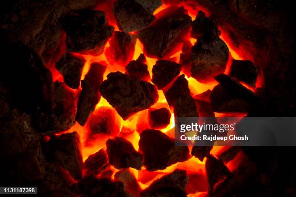 burning coal oven - winter and warm glow stock-fotos und bilder