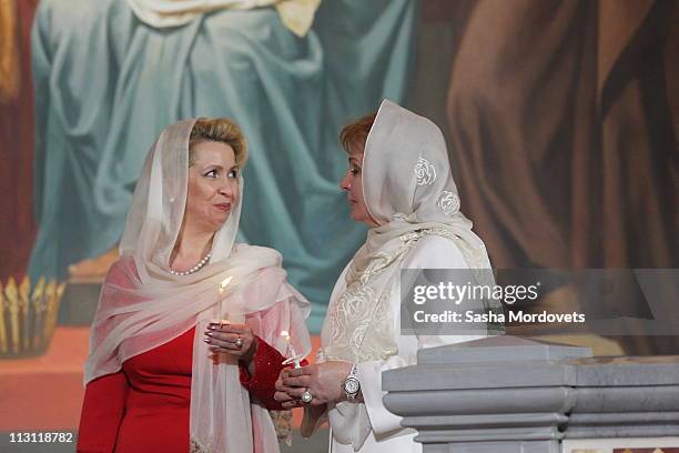 Russia's first lady Svetlana Medvedeva and Prime Minister Vladimir Putin's wife Lyudmila Putina pray during an Orthodox Easter service in the Christ...