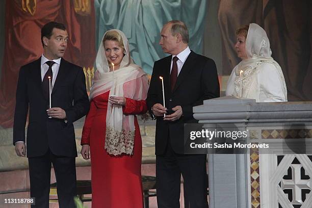 Russia's President Dmitry Medvedev , first lady Svetlana , Prime Minister Vladimir Putin and his wife Lyudmila pray during an Orthodox Easter service...