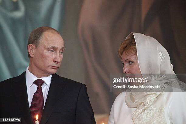 Russia's Prime Minister Vladimir Putin and his wife Lyudmila Putina pray during an Orthodox Easter service in the Christ the Saviour Cathedral on...