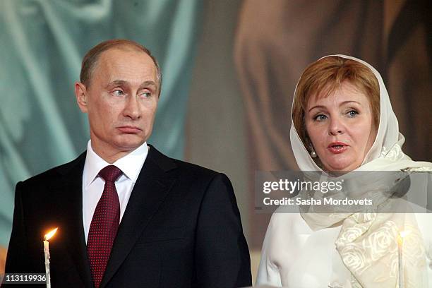Russia's Prime Minister Vladimir Putin and his wife Lyudmila Putina pray during an Orthodox Easter service in the Christ the Saviour Cathedral on...