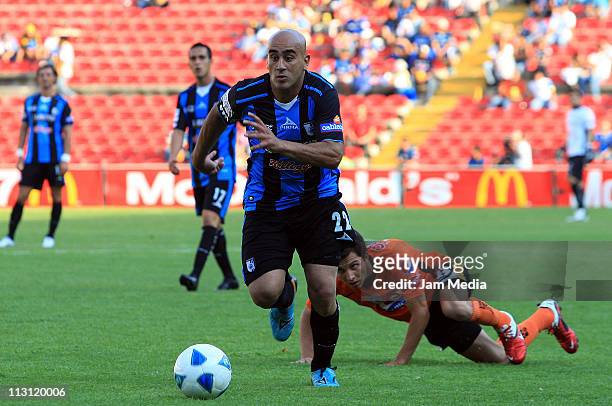 Raul Ferro of Queretaro struggles for the ball with Jose Francisco Torres of Pachuca during their match as part of the Clausura Tournament 2011 at La...