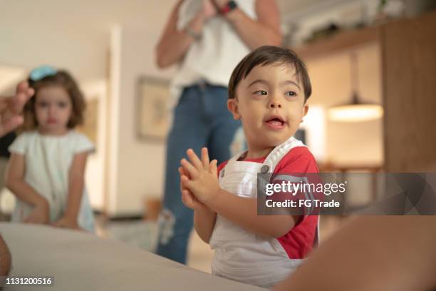 down syndrome boy having fun at home - boy singing stock pictures, royalty-free photos & images