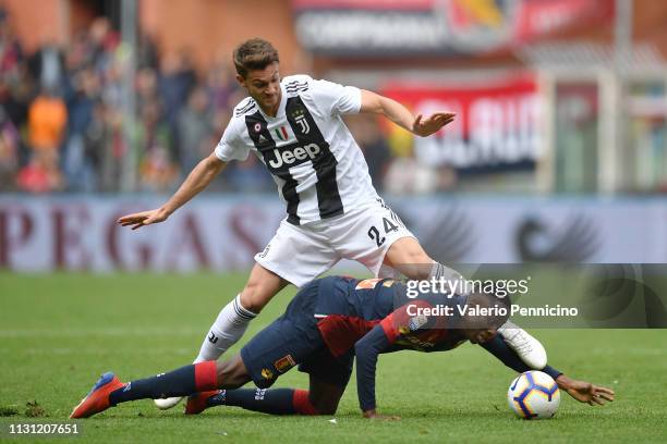 Christian Kouame of Genoa CFC is tackled by Daniele Rugani of Juventus during the Serie A match between Genoa CFC and Juventus at Stadio Luigi...