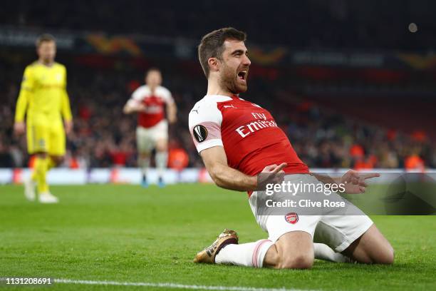 Sokratis Papastathopoulos of Arsenal celebrates after scoring his team's third goal during the UEFA Europa League Round of 32 Second Leg match...