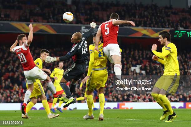 Sokratis Papastathopoulos of Arsenal scores his team's third goal during the UEFA Europa League Round of 32 Second Leg match between Arsenal and BATE...