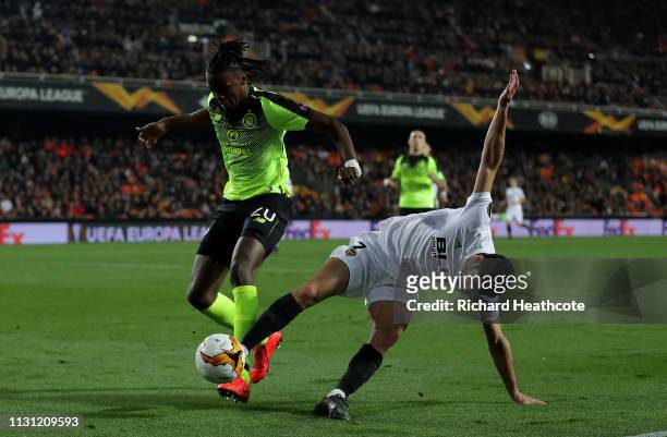 Dedryck Boyata of Celtic is challenged by Goncalo Guedes of Valencia during the UEFA Europa League Round of 32 Second Leg match between Valencia v...