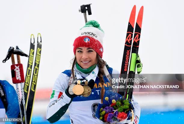 Italy's Dorothea Wierer poses with her gold medal after winning the women's 12,5 km mass start event at the IBU World Biathlon Championships in...