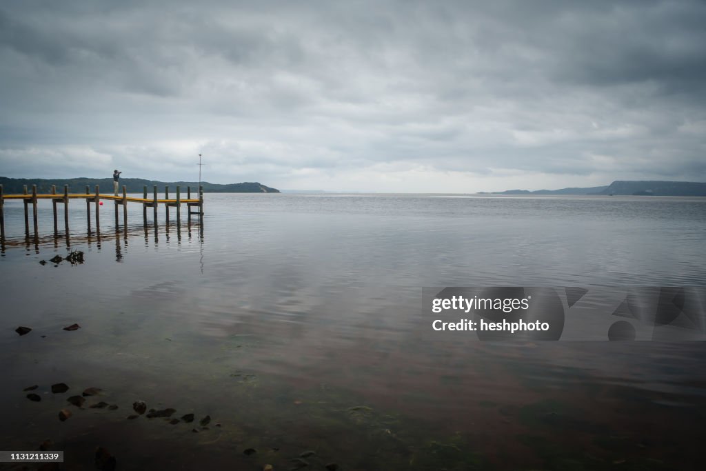 Photographer taking photographs of the coast of Tasmania