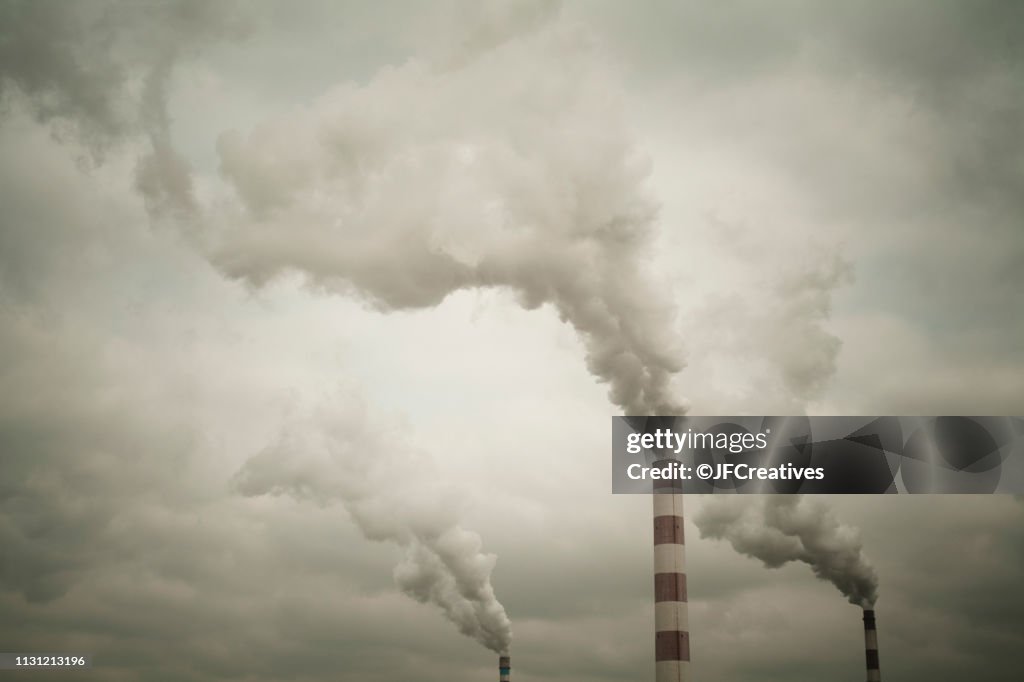 Industrial chimneys smoking